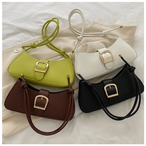 Flat lay of colorful PU leather underarm bags with gold buckles and knotted straps