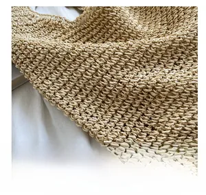 Detailed macro view of high-quality woven texture on a beige handmade shoulder bag