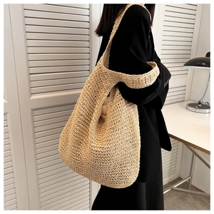 Close-up of a handmade woven beige tote bag with a natural textured knit pattern