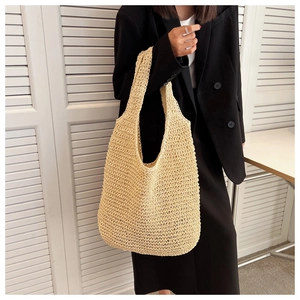 Macro detail of beige woven tote bag showing intricate mesh texture and craftsmanship