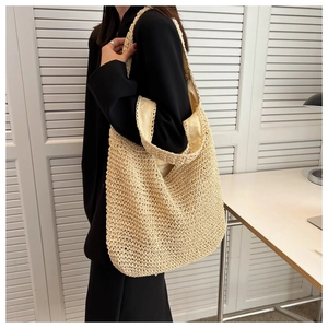 Detail of hand-woven beige tote bag showing soft texture and large capacity