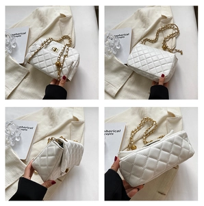 Detail of white quilted chain bag with gold hardware and spherical adjustment buckle