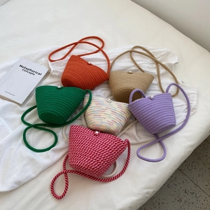 Handmade crochet mini bucket bags in six vibrant colors with pearl buttons and long straps