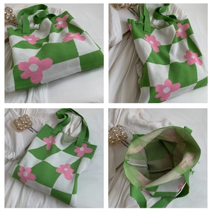 Detail view of the green checkered knit tote bag with pink flower patterns and texture