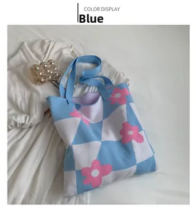 Detail of blue and white checkered knitted tote bag with pink floral jacquard pattern