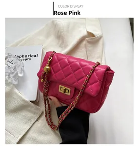 Detailed close-up of rose pink quilted leather bag with gold chain and ball ornament