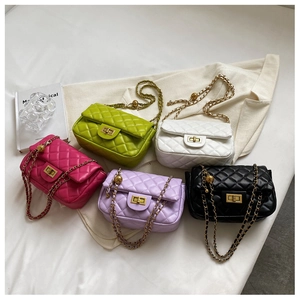 Flat lay of quilted crossbody bags in rose, green, white, purple and black with gold chains