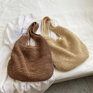 Handmade woven tote bag in brown and beige colors for summer leisure and shopping