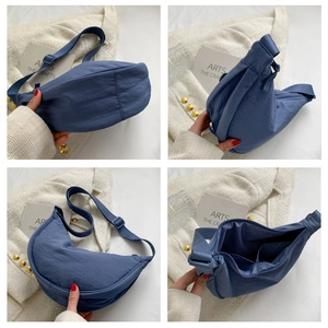 Detail view of blue nylon crescent bag with adjustable strap and inner pocket layout