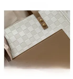 Detail of white textured leather and brown pocket with gold studs and silk scarf