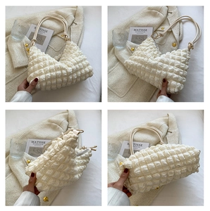 Detailed views of the cream pleated bubble bag showing its unique texture and zipper closure