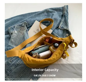 Internal capacity of the mustard yellow nylon crossbody bag showing multiple pockets