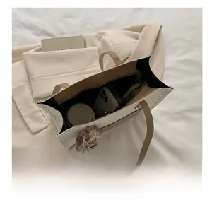 Top view of large white leather tote bag showing spacious interior with scarf detail