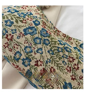 Detail of vintage floral jacquard fabric showing intricate blue and red woven patterns