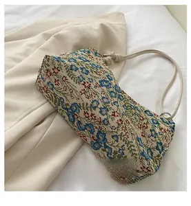 Detailed close-up of floral embroidery texture and base craftsmanship on the shoulder bag