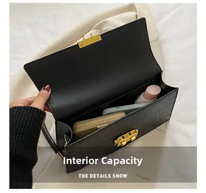 Interior view of black embossed crossbody bag showing capacity for phone and wallet