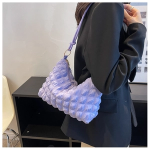 Close-up of light purple bubble texture underarm bag with knotted shoulder strap