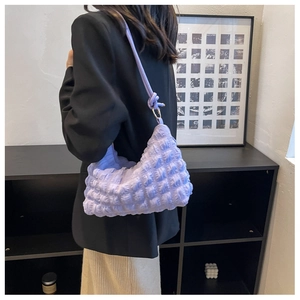 Close-up of a lilac bubble textured shoulder bag featuring chic knot strap details