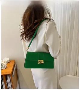 Bright green faux stone texture underarm bag with gold metal buckle shown on a model