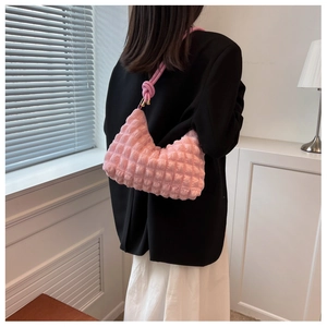 Close-up of pink bubble texture shoulder bag with stylish knotted strap detail