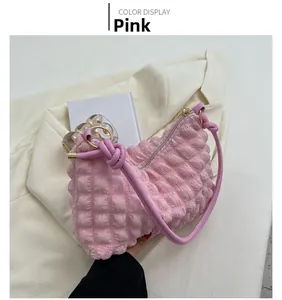 Detail of pink bubble bag showing waffle pleated texture and knot with gold ring