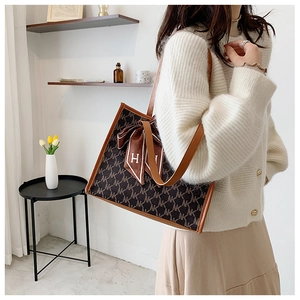 Large vintage tote bag with NK monogram pattern and silk ribbon detail on shoulder strap