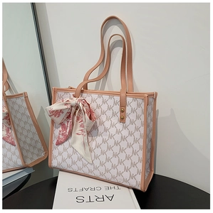 Close-up of large capacity pink and white tote bag with MK print and silk scarf