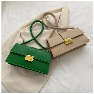 Detail view of retro crocodile texture crossbody bags with golden buckle and round straps