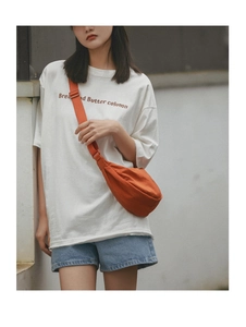 Outdoor look featuring a casual orange nylon crescent waist bag and white graphic T-shirt