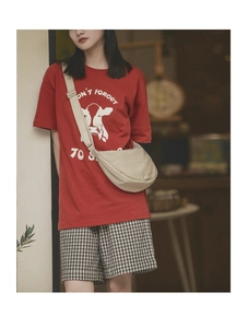 Beige nylon crescent crossbody bag styled with casual outfit for a minimalist look