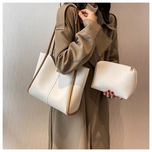 Detail of minimalist cream tote bag set with brown contrast trim and matching inner pouch