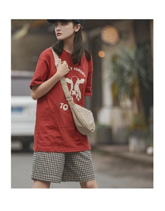 Close-up of red short-sleeve cotton T-shirt featuring a retro cow print and graphic text