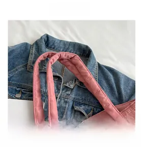 Detailed view of pink quilted tote bag with soft padded handles and neat stitching