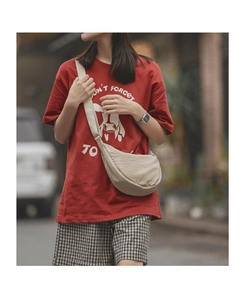 Close-up of beige nylon crescent bag with adjustable strap and durable fabric texture