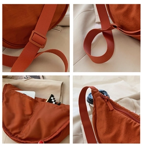 Detail of caramel nylon crescent bag with adjustable strap and multiple storage pockets