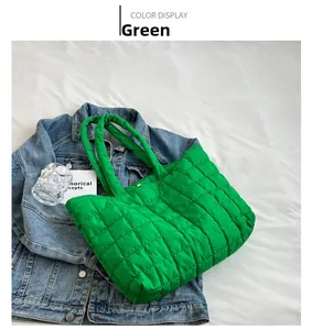 Detail view of the green quilted tote bag with soft padded texture and top handle