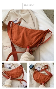 Multiple views of an orange nylon crescent crossbody bag with adjustable strap and zip