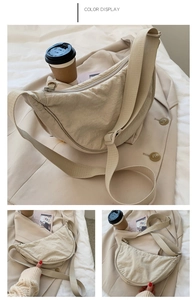 Close-up of beige nylon crescent bag with adjustable shoulder strap and soft fabric texture