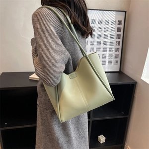 Minimalist pistachio green tote bag with vertical stitching and slim shoulder straps