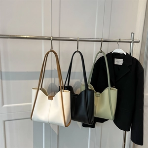 Minimalist large capacity tote bag displayed in white, black and green leather options