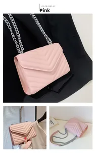 Detailed view of a pink chevron quilted crossbody bag with a silver chain strap