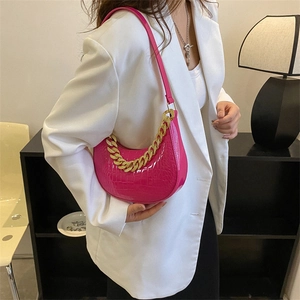 Fuchsiafarbene Umhängetasche mit Krokodilmuster und goldener klobiger Kette als Dekor