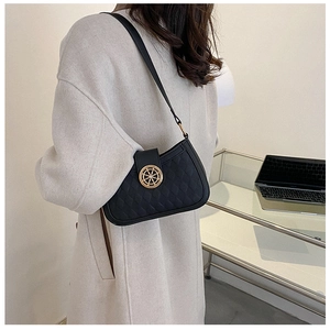 Détail du sac demi-lune matelassé noir avec fermoir doré et bandoulière en cuir