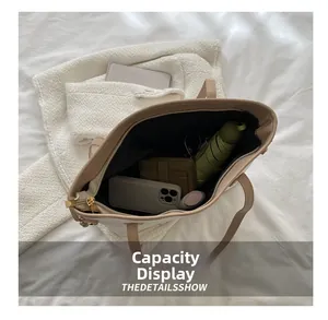 Internal view of large capacity tote bag showing phone, umbrella and golden zipper detail