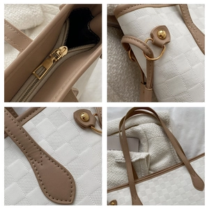 Detail of white checkered tote bag featuring gold hardware and brown leather stitching
