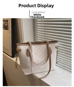 Detail of checkered white tote bag with drawstring side and light brown strap