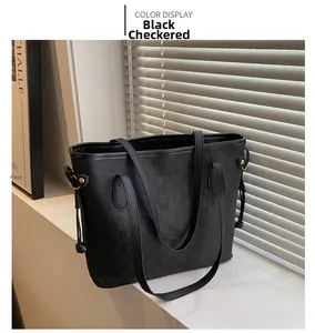 Close-up of checkered black tote bag with side drawstring and gold hardware details