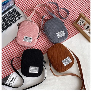 Detail showing four colors of corduroy crossbody bags with Fashion Instinct label