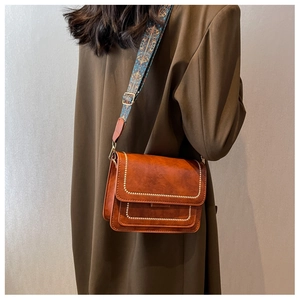 Brown retro crossbody bag with beaded stitching and ethnic style wide woven strap