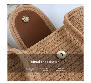 Detailed macro shot of the metal magnetic clasp on a woven straw handbag